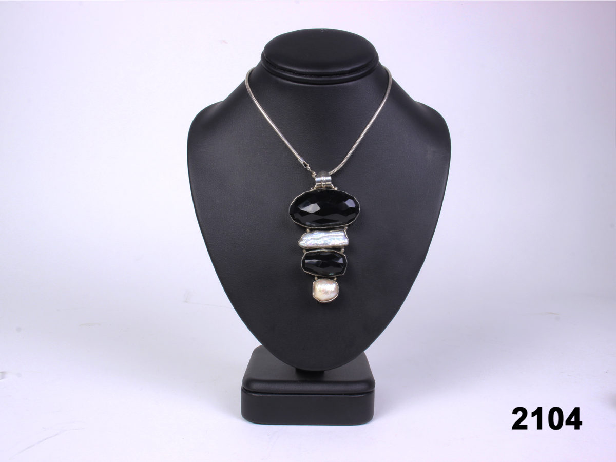 Front view of 925 Sterling silver jet and fresh water pearl pendant on 925 silver snake chain from Antiques of Kingston.