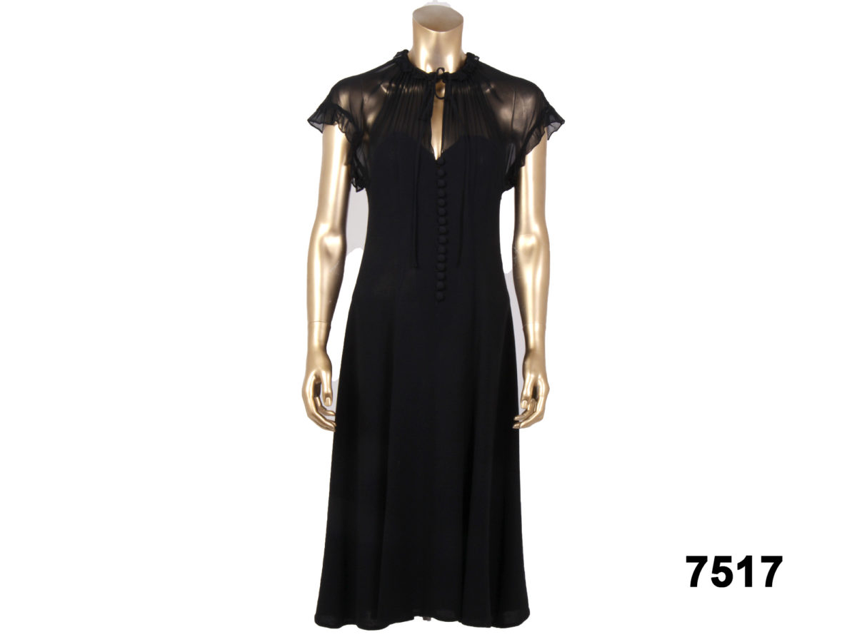 Front view of 1970s Radley dress in black crepe with button front & sheer top from Antiques of Kingston