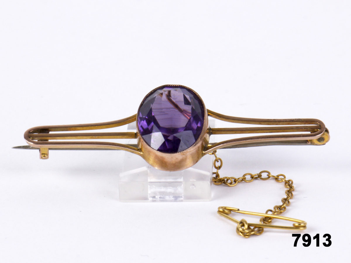 Front view of 9 carat Gold bar brooch with a large oval cut amethyst to the centre & a safety chain & pin from Antiques of Kingston