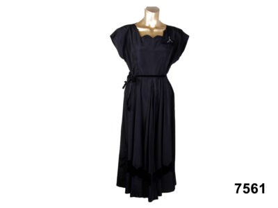 Front view of 50s black taffeta dress with velvet detail and lightly padded shoulders from Antiques of Kingston