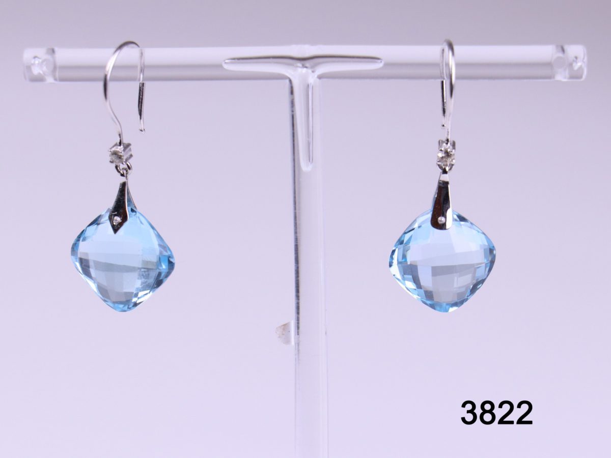 18 carat white gold hook earrings with cushion cut blue topaz drop and small diamond on hook base from antiques of kingston