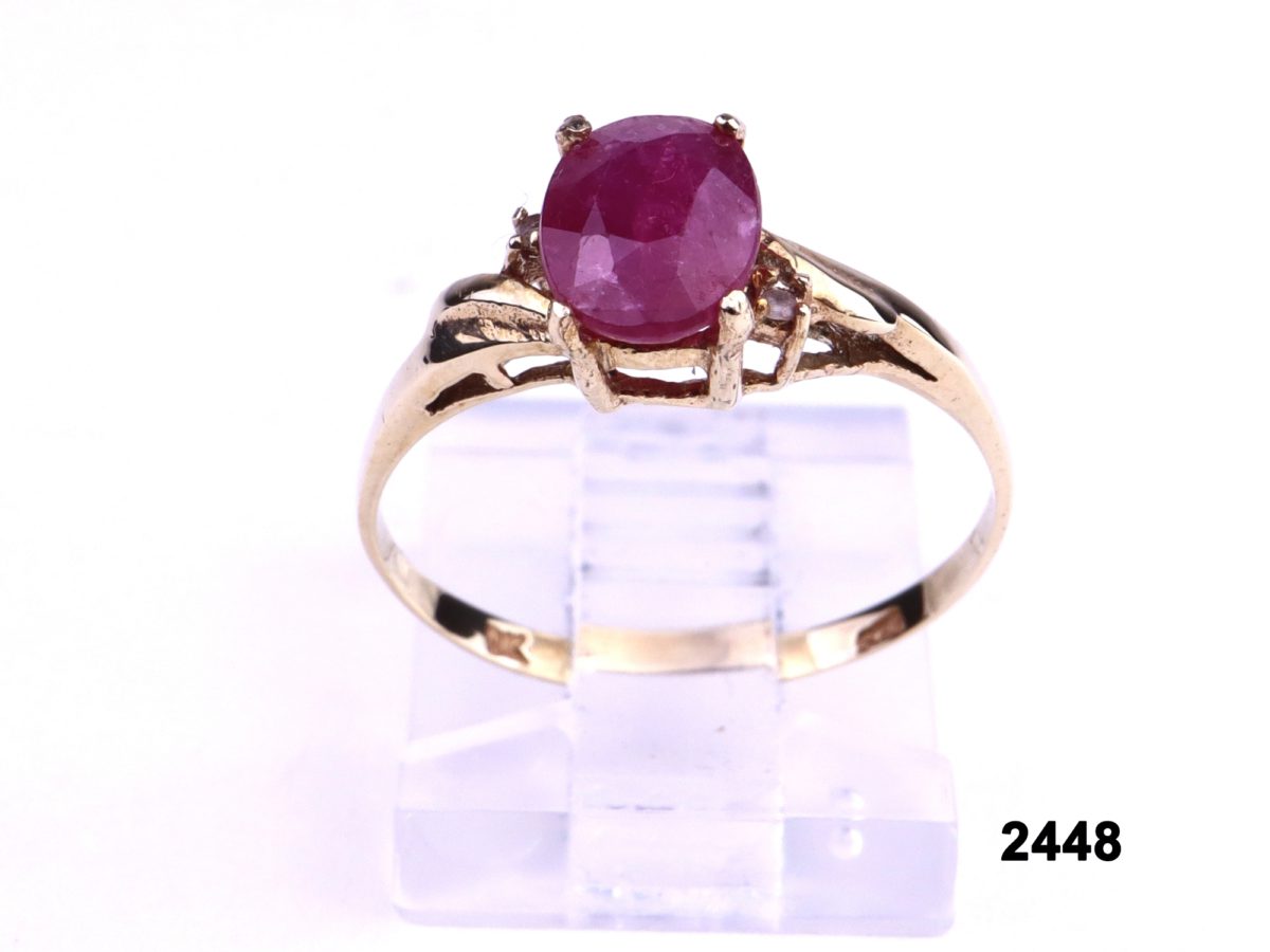 9 carat Gold ring set with oval cut ruby and a diamond on each shoulder from Antiques of Kingston