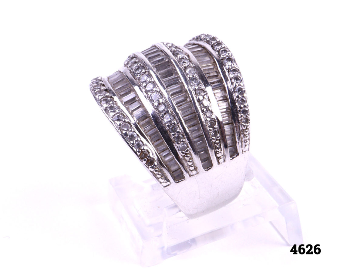925 Sterling silver ring with alternating layers of round and baguette cut cubic zirconia stones Raised side view