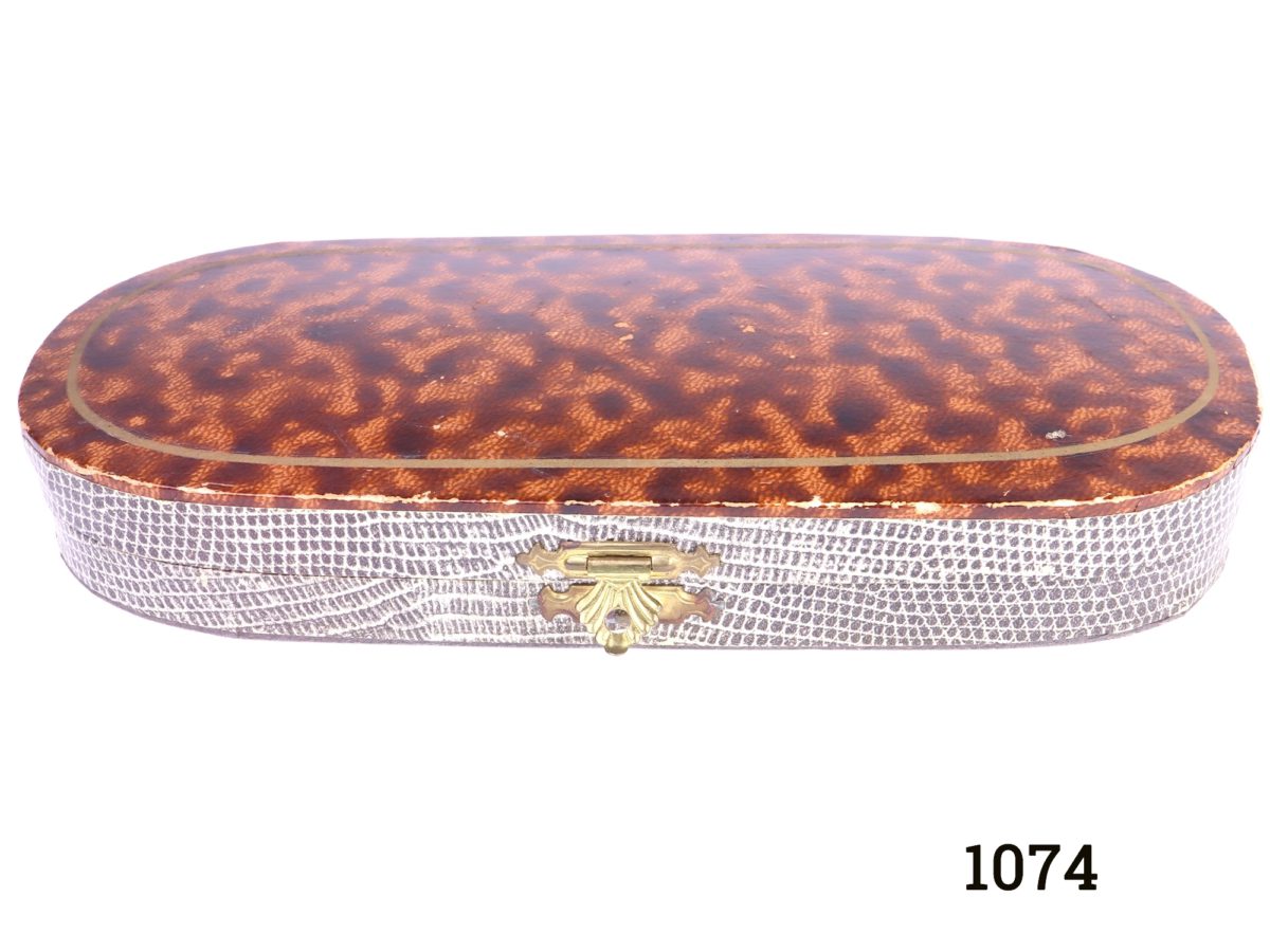 Vintage Cased Sewing Set Photo of front view of case with lid closed showing tortoise shell print on lid and snake skin print below