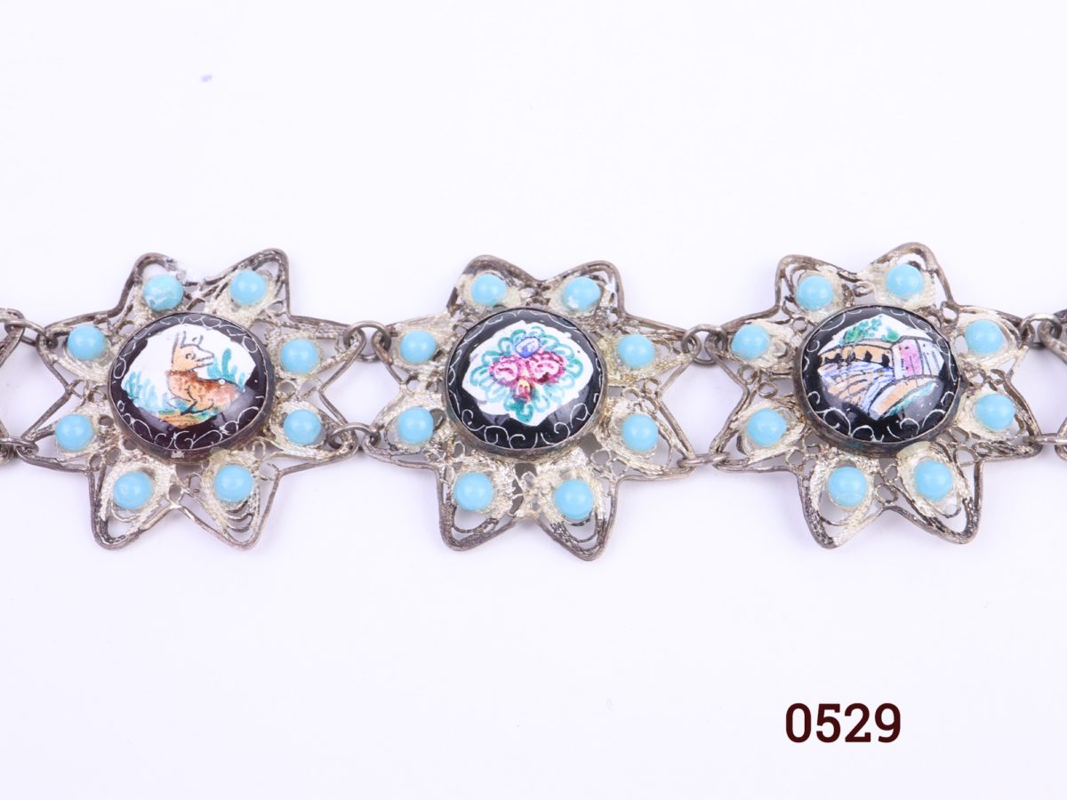 Vintage white metal bracelet with 8 enamelled circles of a flora & fauna theme and turquoise beads around each enamel picture creating a flower like effect Close up image of 3 of the enamel sections