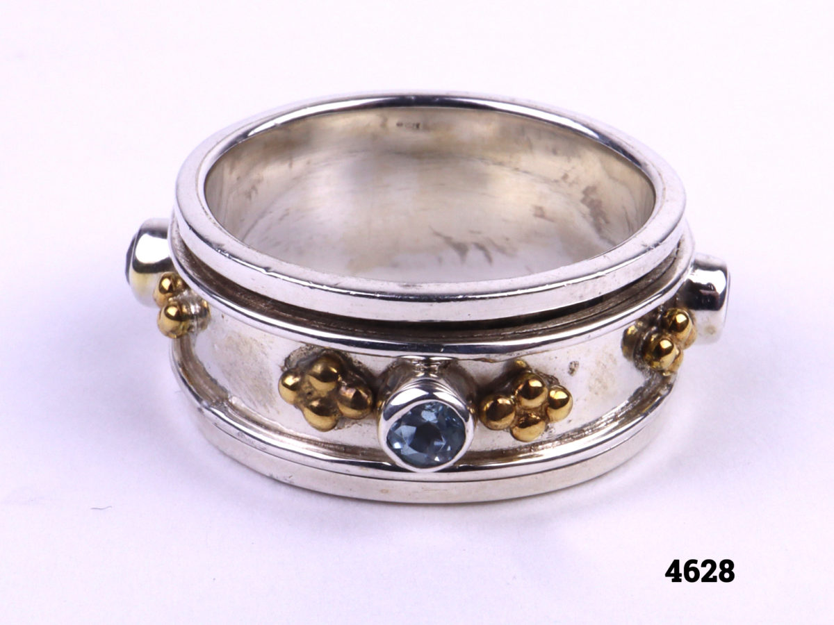 Silver Ring with spinning mid section adorned with small pale blue stones and gilt decoration from Antiques of Kingston