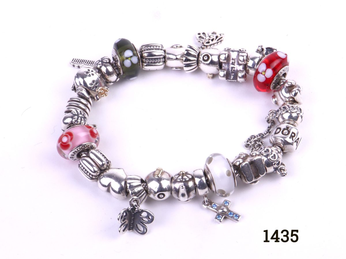 Pandora silver bracelet fully loaded with 22 charms Photo showing full bracelet flat