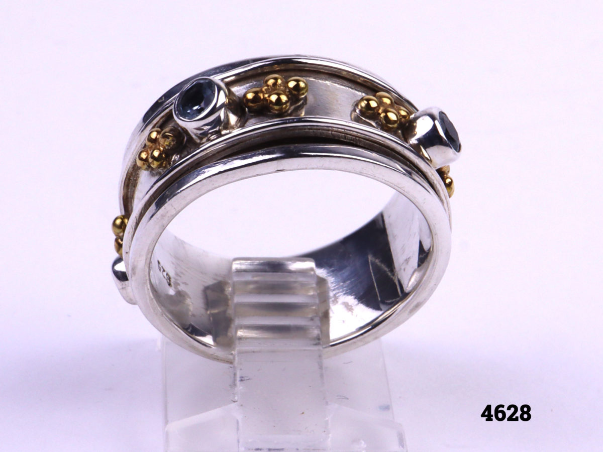 Silver ring with Spinning mid section adorned with pale blue stones and gilt decoration