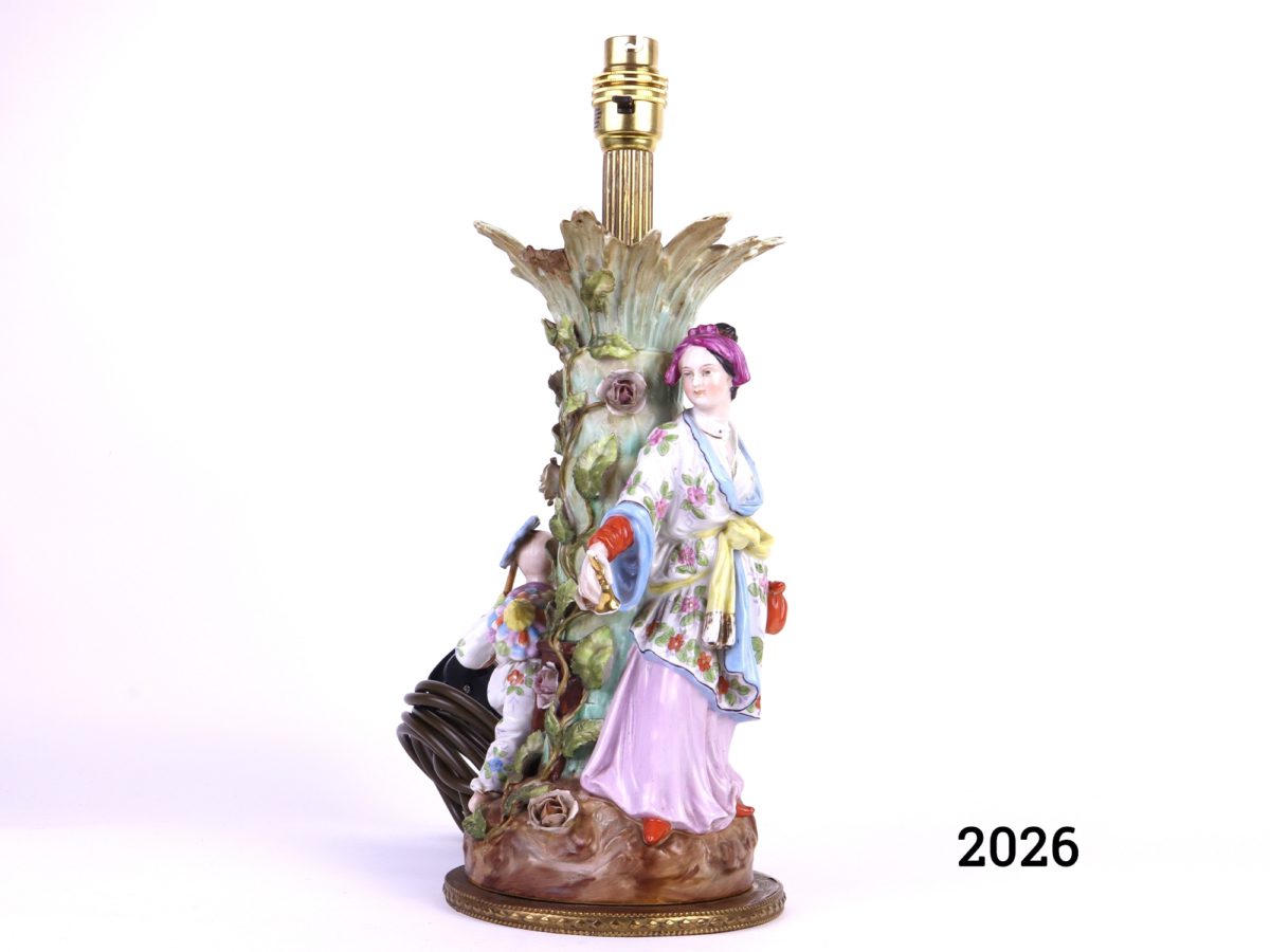 Antique continental porcelain lamp decorated with a woman and child in oriental dress playing around a tree (Some damage as shown - missing leaf) Measures 140mm in diameter at base Main photo showing taller figure