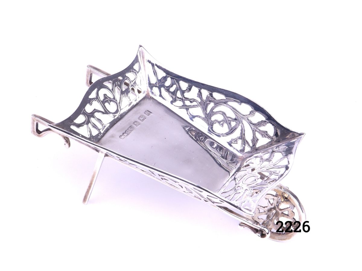 Small sterling silver wheelbarrow with filigree scroll work on all the sides Made by M & C Lister c1934 Birmingham assayed Photo showing wheelbarrow from a higher angle