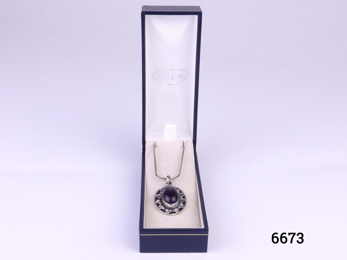 925 Sterling silver and amethyst cabochon pendant on a sterling silver snake chain Pendant drop length 32mm Measures 24mm by 18mm Chain measures 405mm long Weight 9.4g Photo of necklace in box