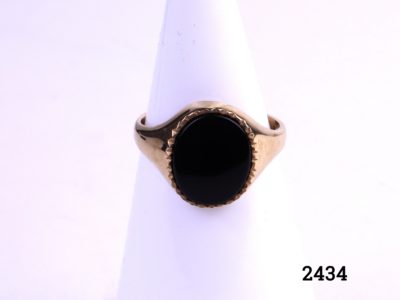 9ct Gold signet ring with black onyx c1988 Birmingham assayed fully hallmarked 375 and makers stamp AK Stone size 12mm by 10mm Size P / 7.5 Main photo of ring displayed on stand showing onyx front