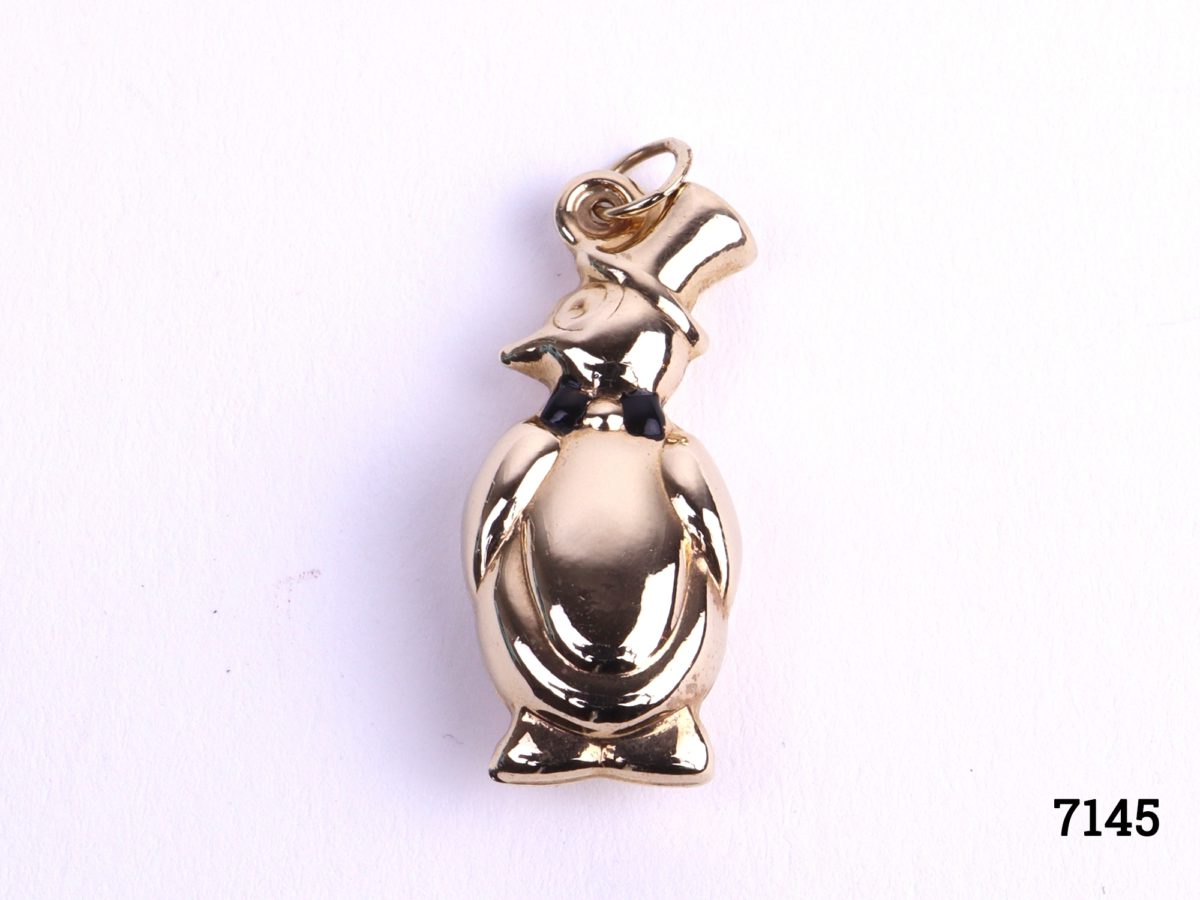 c1991 Sheffield assayed 9carat gold penguin charm with black enamel bow tie Fully hallmarked with goldsmiths initials LJ Main photo of penguin on flat surface showing front side with enamelled black bow tie