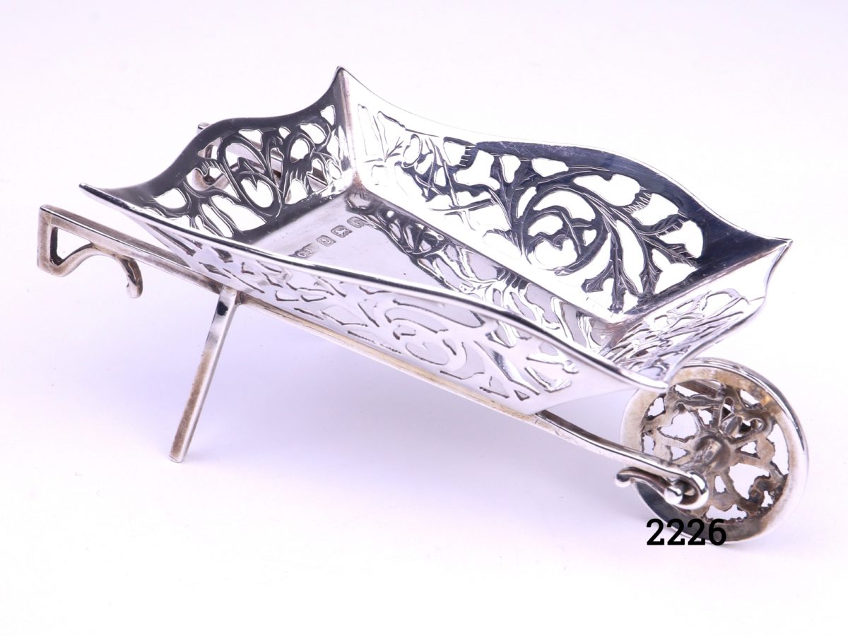 Small sterling silver wheelbarrow with filigree scroll work on all the sides Made by M & C Lister c1934 Birmingham assayed Main photo showing angled front and side view