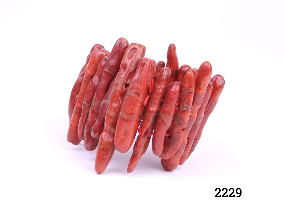 Restrung branch coral bracelet consisting of large pieces of red branch coral on double elastic Approximate width 50mm (Coral sizes vary) Photo of bracelet on flat surface