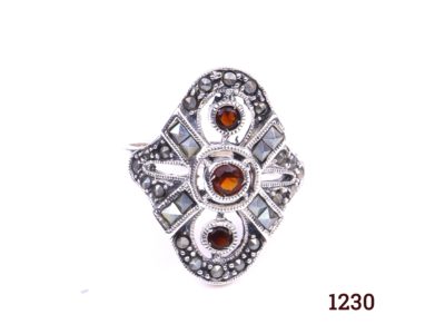 Silver and garnet ring. 925 Sterling silver ring set with three garnets and marcasite in an Art Deco style. Size R / 8.5. Ring front measures 25mm by 22mm. Main photo showing front of ring