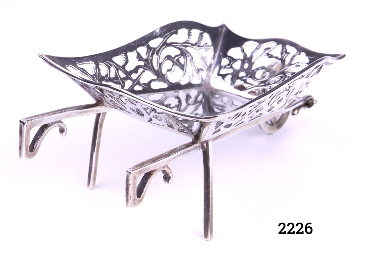 Small sterling silver wheelbarrow with filigree scroll work on all the sides Made by M & C Lister c1934 Birmingham assayed Photo showing the back of the wheelbarrow handles and back supports