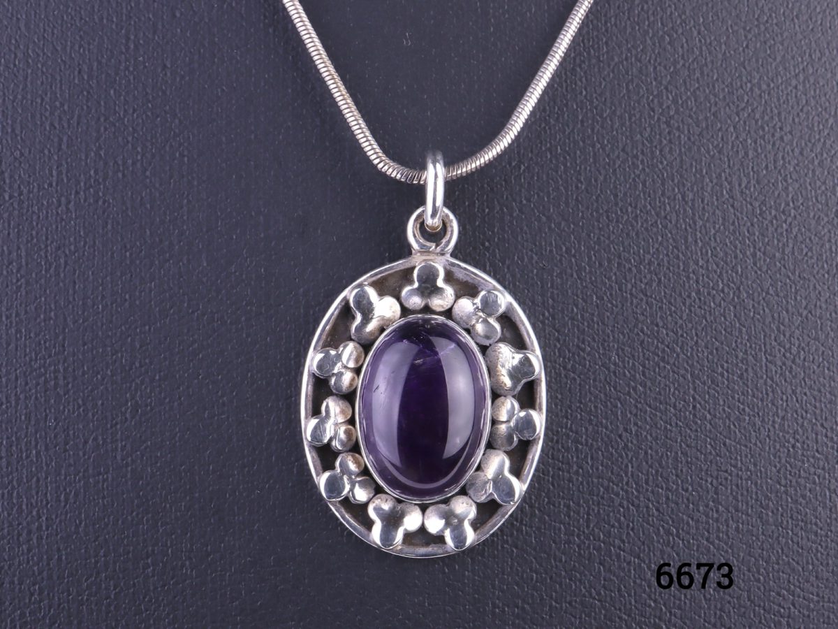 925 Sterling silver and amethyst cabochon pendant on a sterling silver snake chain Pendant drop length 32mm Measures 24mm by 18mm Chain measures 405mm long Weight 9.4g Close up photo of the pendant