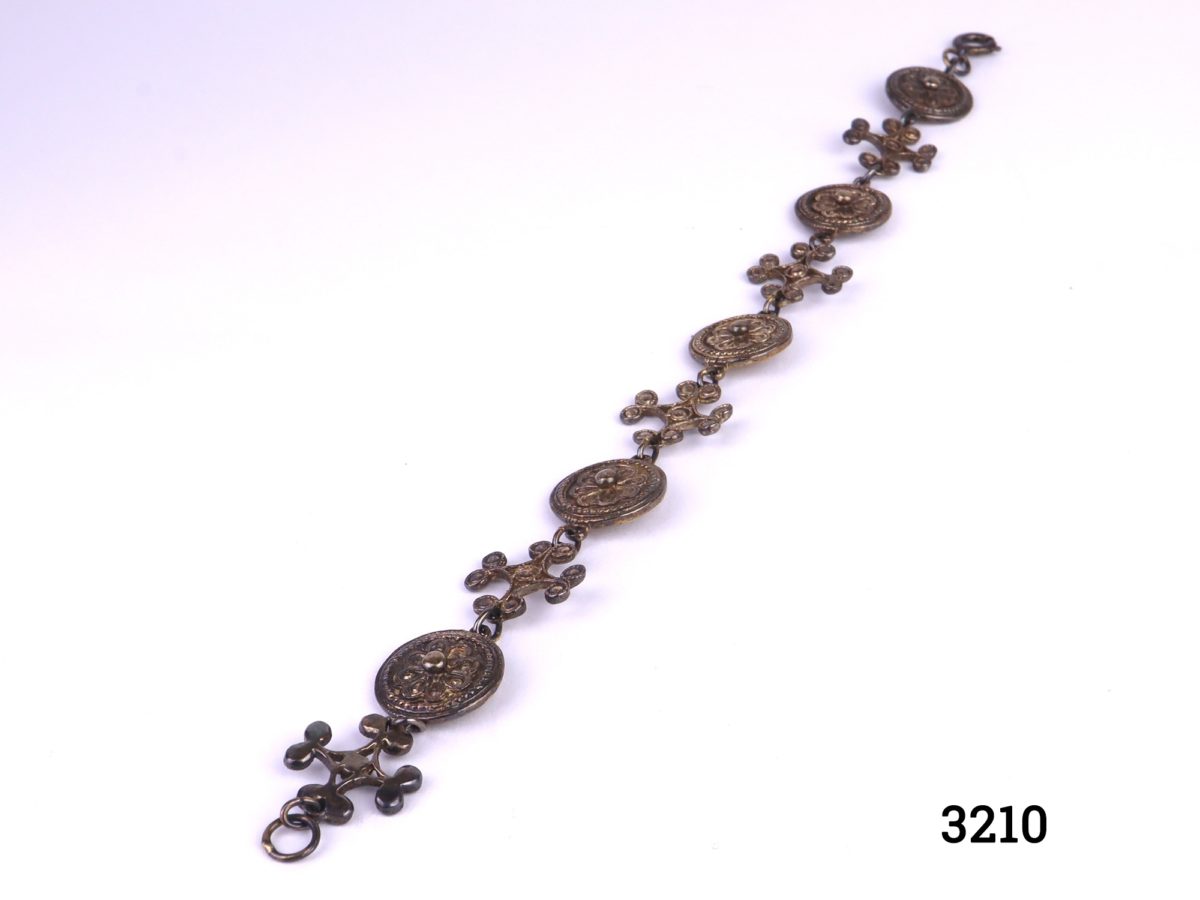 Gilt sterling silver 7th Century BC copy of bracelet using design combinations of gold plaques & gold ear pendant found at Camirus, Rhodes and dress-ornaments from Ephesus excavations. Photo showing fully spread out bracelet on flat surface
