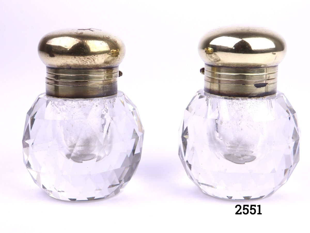 Pair of vintage cut glass inkwells with faceted sides and brass tops (Some signs of wear to the brass tops) Each measures 35mm in diameter at base Main photo of both inkwells side by side