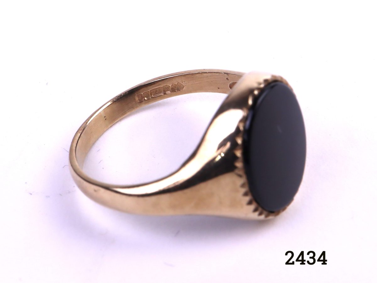9ct Gold signet ring with black onyx c1988 Birmingham assayed fully hallmarked 375 and makers stamp AK Stone size 12mm by 10mm Size P / 7.5 Close up photo showing hallmark
