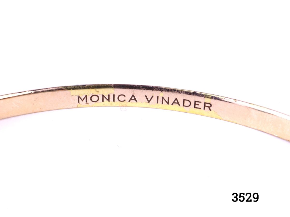 Monica Vinader thin cuff bracelet in 18ct rose gold vermeil on 925 sterling silver with two mutifaceted amazonite stones at both ends Close up photo of makers name in full
