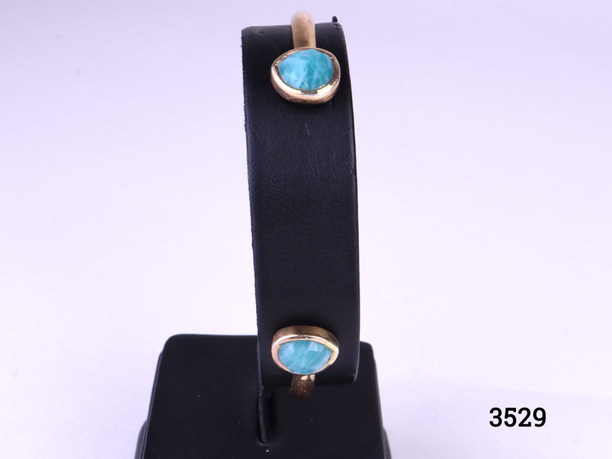 Monica Vinader thin cuff bracelet in 18ct rose gold vermeil on 925 sterling silver with two mutifaceted amazonite stones at both ends Photo showing bracelet displayed on stand
