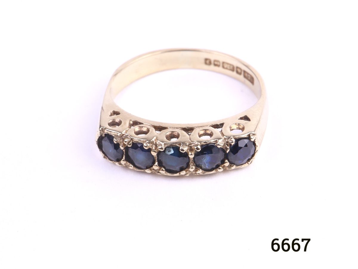 c1980 Birmingham assayed 9ct gold ring with 5 small sapphires by goldsmiths PDL Size L / 5.75 Ring weight 2.8g Close up photo of front view of ring on flat surface
