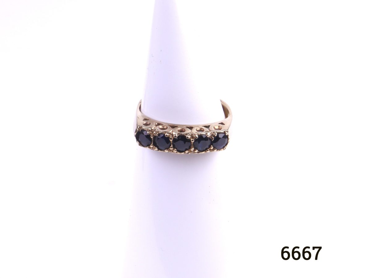 c1980 Birmingham assayed 9ct gold ring with 5 small sapphires by goldsmiths PDL Size L / 5.75 Ring weight 2.8g Photo of front view of ring on a display stand