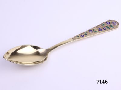 Gilt silver Russian spoon with hand-painted blue enamel vine flowers with green leaves to handle Hallmarked 875 with star, sickle and hammer mark Main photo showing full spoon with enamel detail