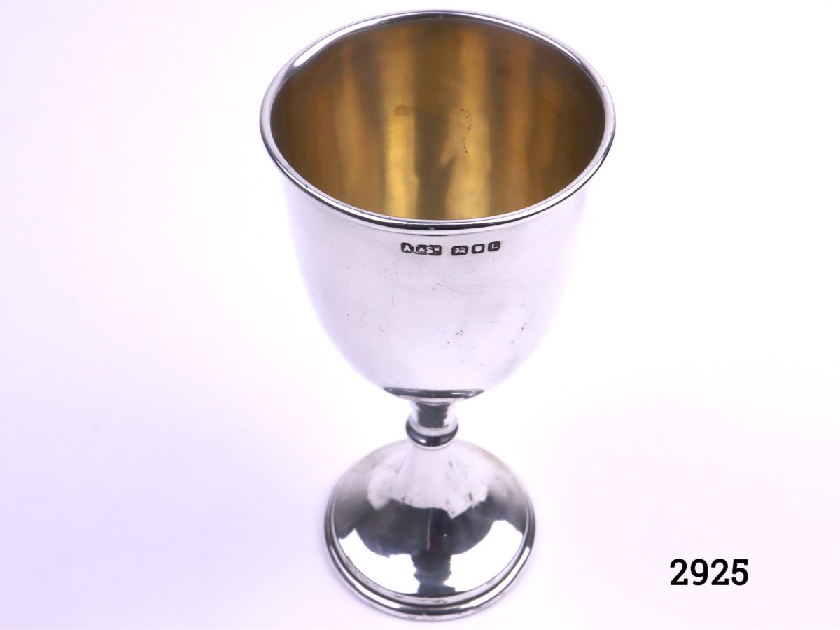 London assayed silver cup with gilt interior Fully hallmarked for sterling silver c1946 by A Taylor & Son Measures 52mm in diameter at base & 60mm across the top Photo from a slightly raised angle showing the gilt interior and hallmark on the outside of cup