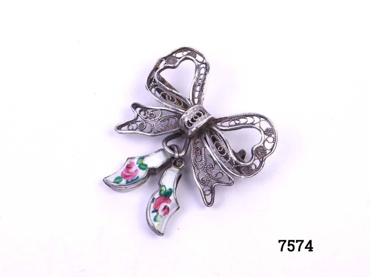 Sterling silver filigree bow brooch with attached pair of silver & enamel white clogs with hand-painted roses to each Photo looking down at brooch from an angled view