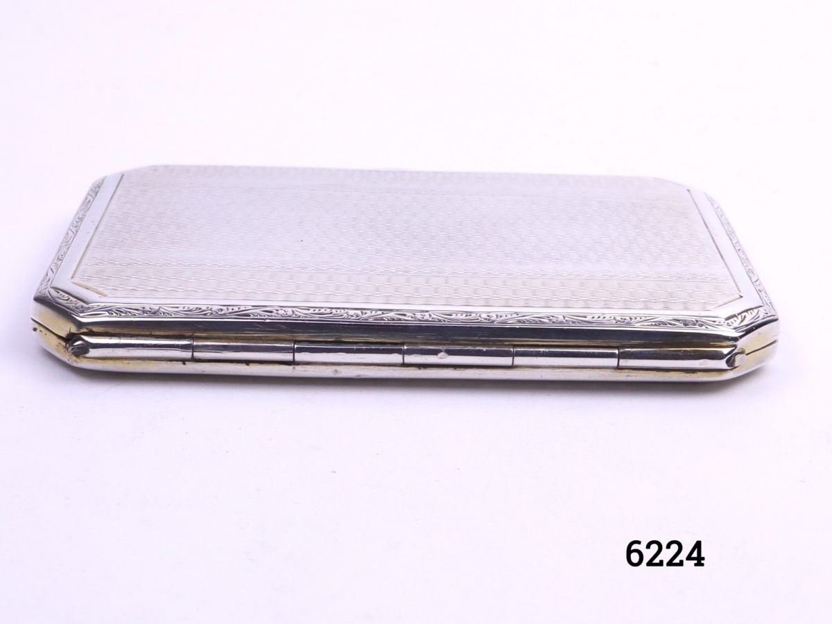 Small silver cigarette case with engine turned design on both sides Made by Turner & Simpson of Birmingham c1930/31 Photo of hinged back part of case on a flat surface
