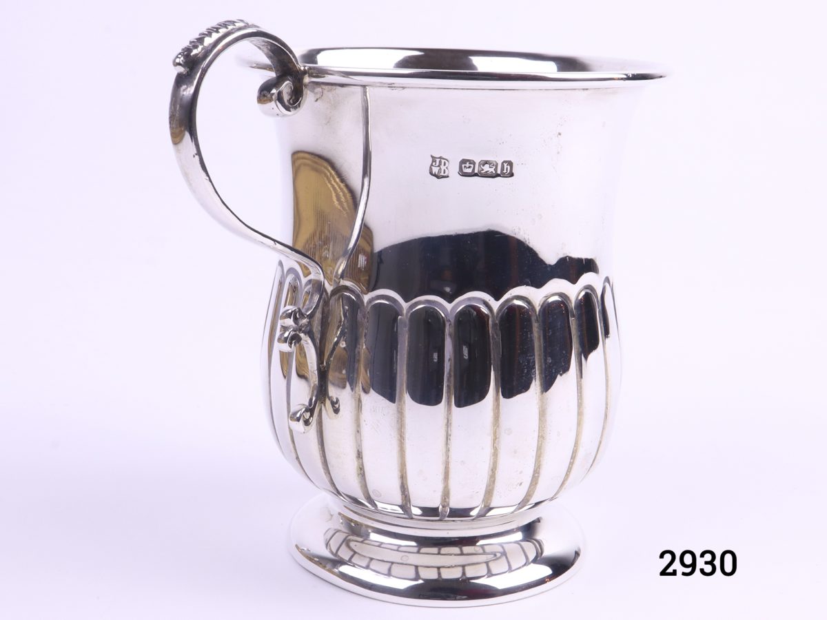 Small sterling silver mug with gilt interior c1920 Sheffield assayed made by James Deakin and Sons Measures 52mm in diameter at base and 70mm across the top Main photo showing mug with handle to the left and hallmark visible just to the right of handle