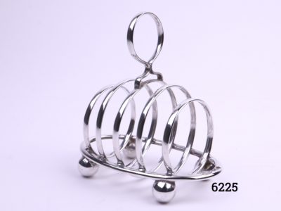 Small Walker & Hall silver toast rack in a barrel like form Fully hallmarked for sterling silver c1919-1920 Sheffield assayed Main photo of the toast rack from a slight angle showing the barrel like shape