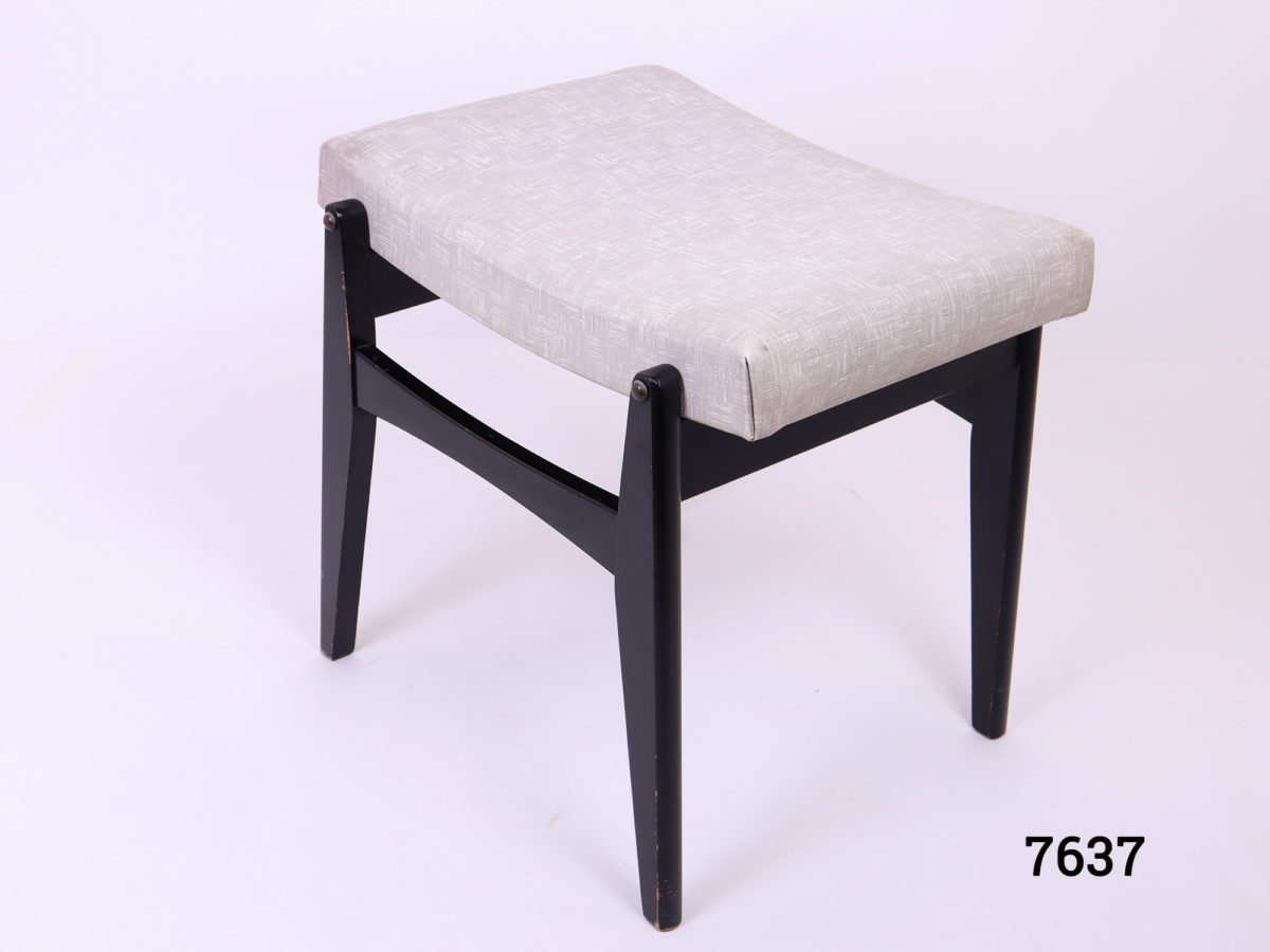 1960s Retro G-Plan stool with grey pvc seat and ebonised legs (Some wear on the base). Seat area measures 450mm long by 60mm high Photo of stool from an angle