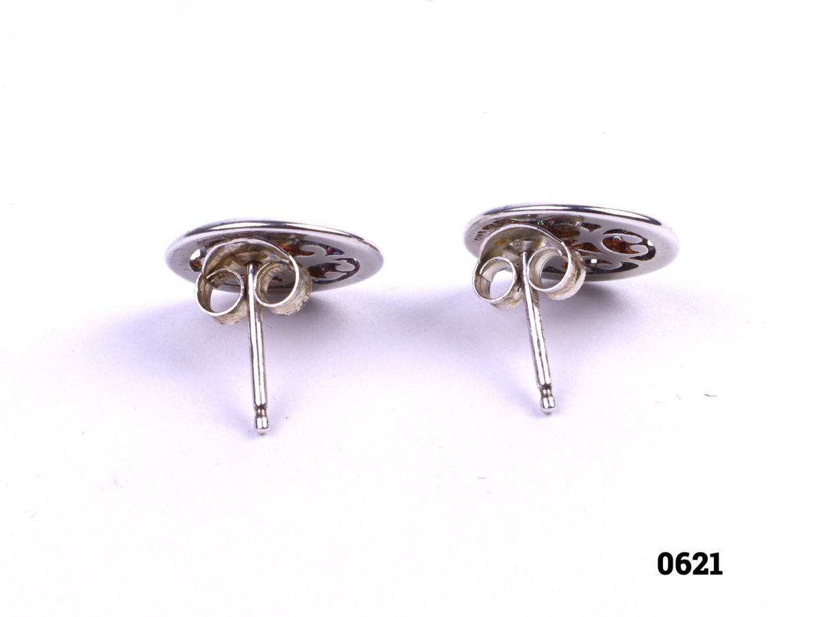 Ola Gorie silver stud earrings. Made in the Orkney Islands. Butterfly back fastening. Comes in original Ola Gorie box. Stud front measures 10mm in diameter. Weight 1.3g Photo showing butterfly fastened backs of earrings