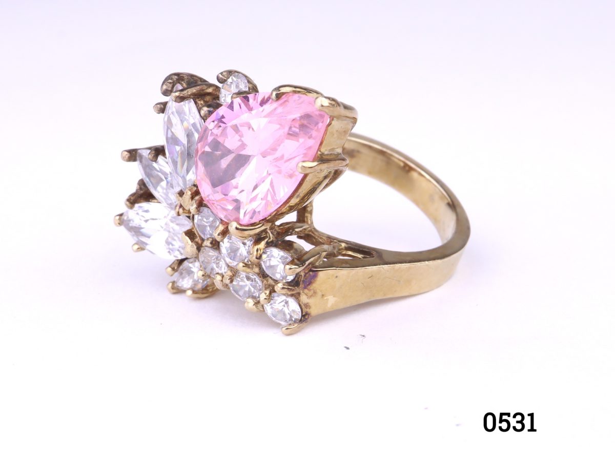 Gold on silver statement ring with pink & white crystals. Ring front measures 20mm by 25mm. Hallmarked 925 for sterling silver. Size K / 5.5   Ring weight 9.7g Photo of ring on a flat surface from a side angle 