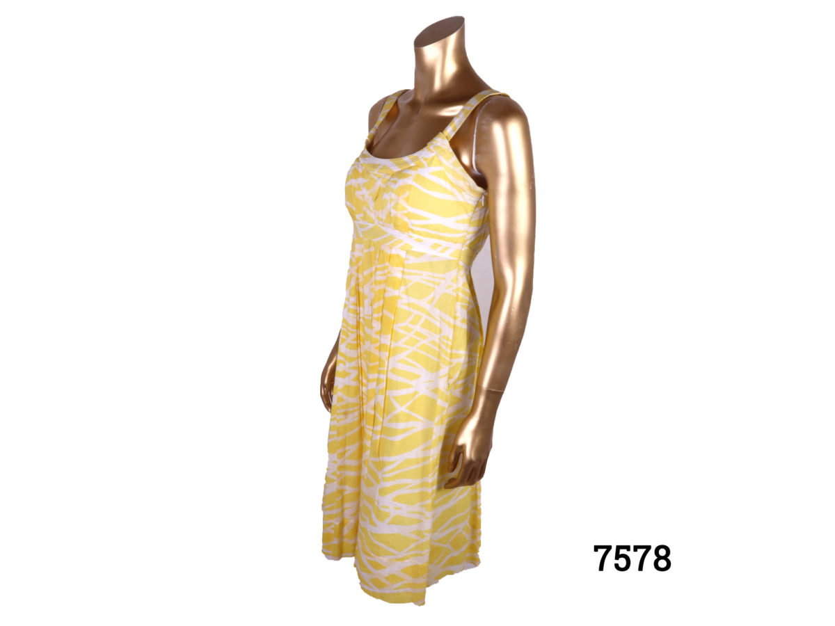Calvin Klein strap dress in yellow and white cotton. Side zip fastening. Size 10 Side view of dress on mannequin