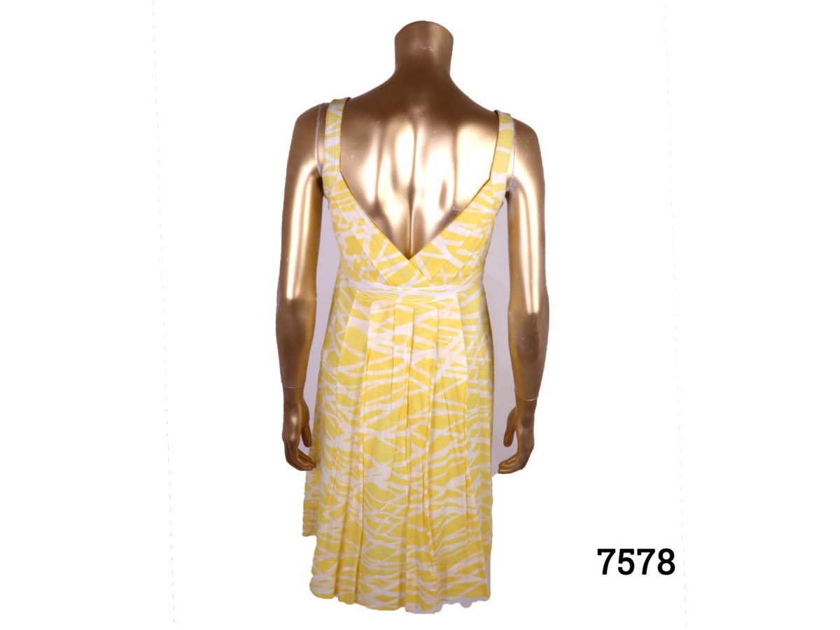 Calvin Klein strap dress in yellow and white cotton. Side zip fastening. Size 10 Back view of dress on mannequin