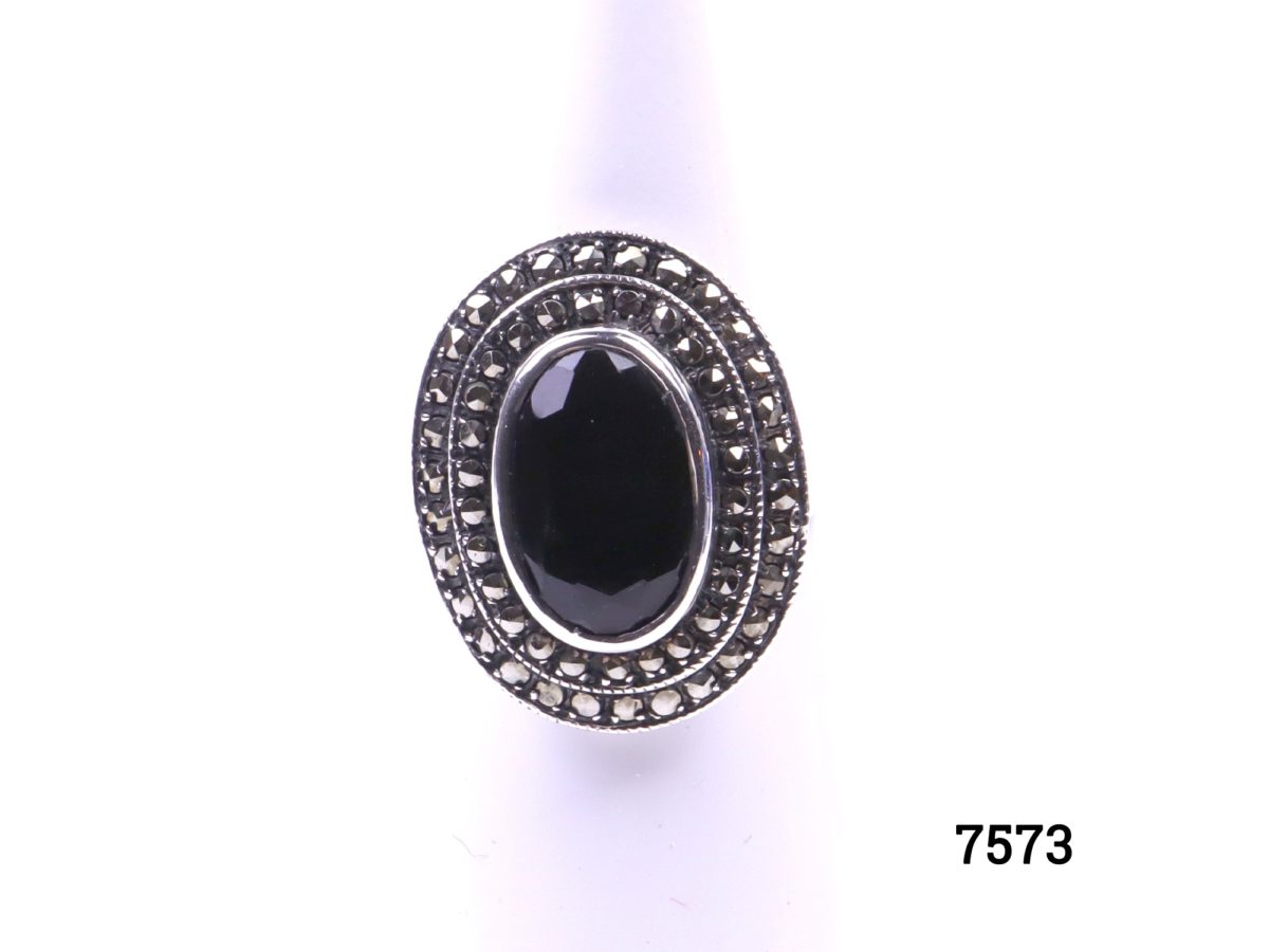 925 Sterling silver ring with black onyx and marcasite. Size Q / 8. Ring frontage measures 23mm by 20mm Main photo of ring displayed on stand showing frontage
