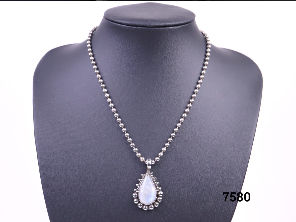 Rainbow (or blue) moonstone teardrop pendant set on 925 sterling silver with ball chain matching the frame around the pendant from Antiques of Kingston