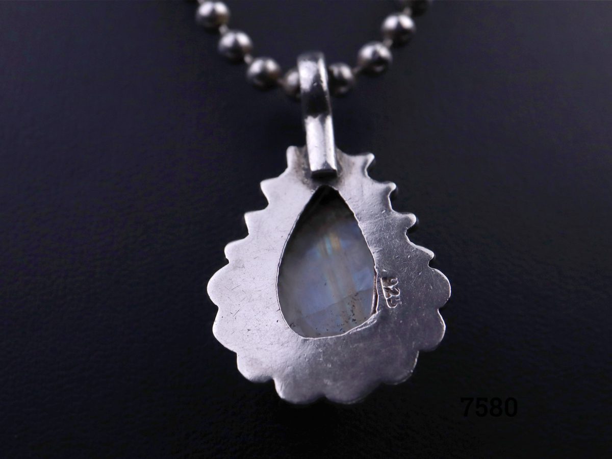 Rainbow or blue moonstone teardrop pendant set on 925 sterling silver with ball chain matching the frame of the pendant Pendant drop length 35mm and weighs 10.2g Close up photo of the back of the pendant showing the hallmark