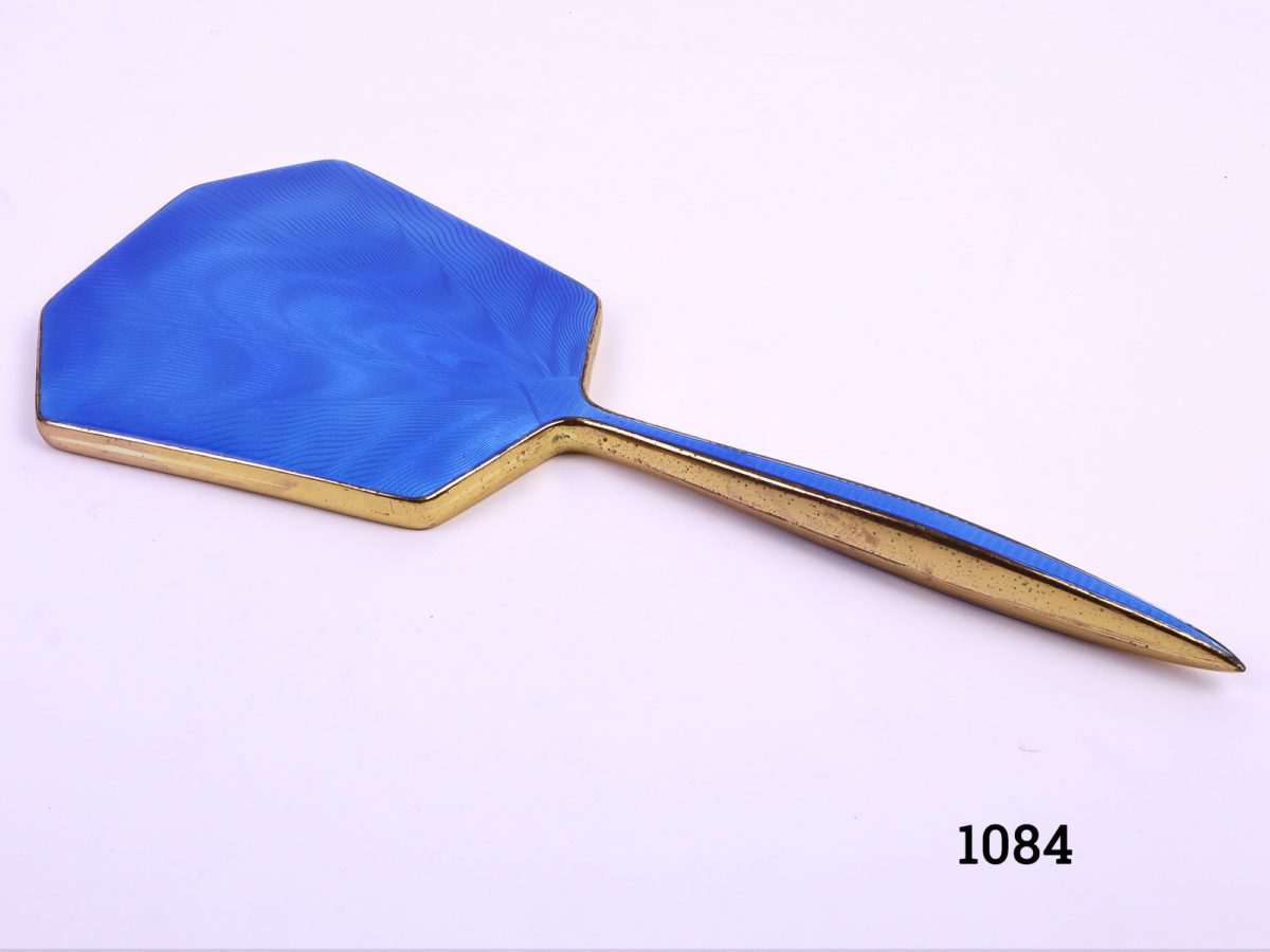 Vintage cased vanity set consisting of cobalt blue backed enamelled hair brush, mirror and clothes brush.  Enamel in excellent condition throughout. Hair brush measures 240mm long x 80mm Mirror measures 280mm x 120mm Clothes brush measures 143mm x 32mm Close up photo of the hand mirror enamel side up