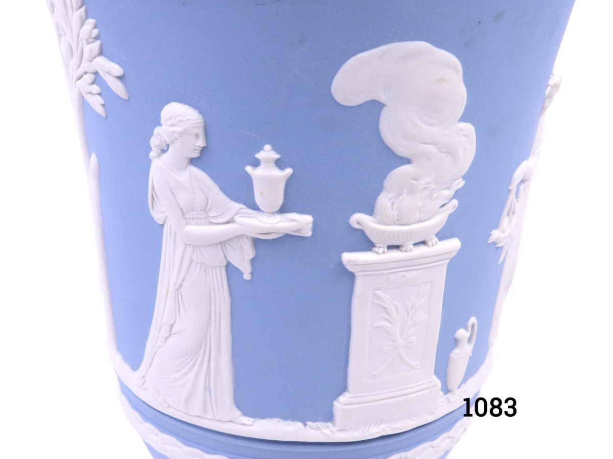 Vintage Wedgwood Jasperware vase in the classic light blue c1975 Measures 76mm in diameter at base and 130mm in diameter across the topVintage Wedgwood Jasperware vase in the classic light blue c1975 Measures 76mm in diameter at base and 130mm in diameter across the top Close up photo of some of the white decoration around the vase