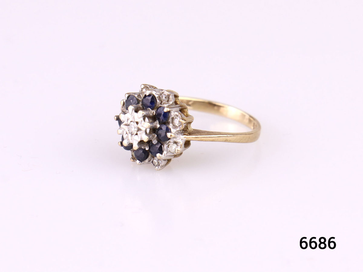 c1976 London assayed 9 karat gold ring with diamonds and sapphires. Fully hallmarked. Size K / 5 Weight 2.7g Photo of ring on flat surface shown from a side angle
