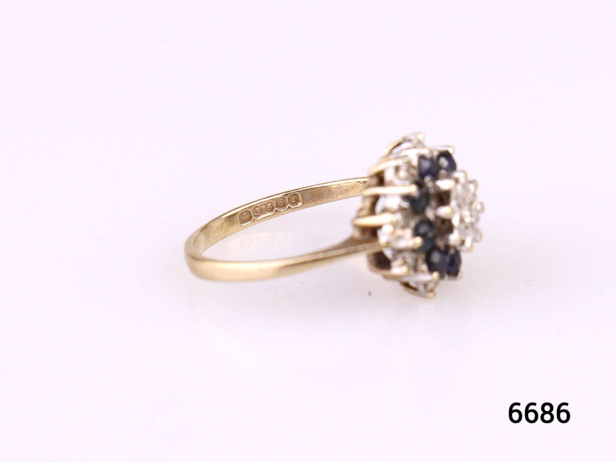 c1976 London assayed 9 karat gold ring with diamonds and sapphires. Fully hallmarked. Size K / 5 Weight 2.7g Photo of ring no flat surface showing the hallmark on the inner band