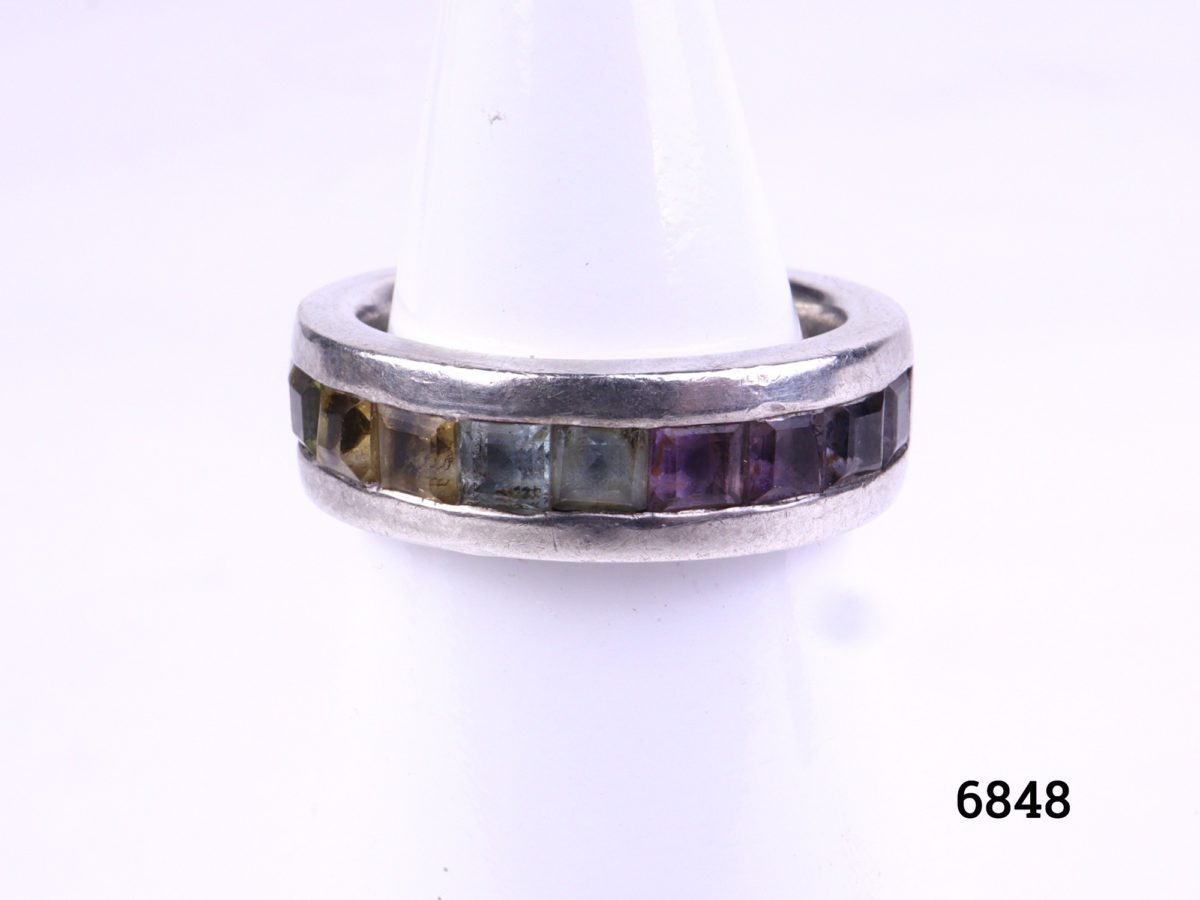 Sterling silver ring with row of rainbow coloured stones. Fully hallmarked for Birmingham assay. Size J / 4.75 Main photo of ring from the front displayed on stand
