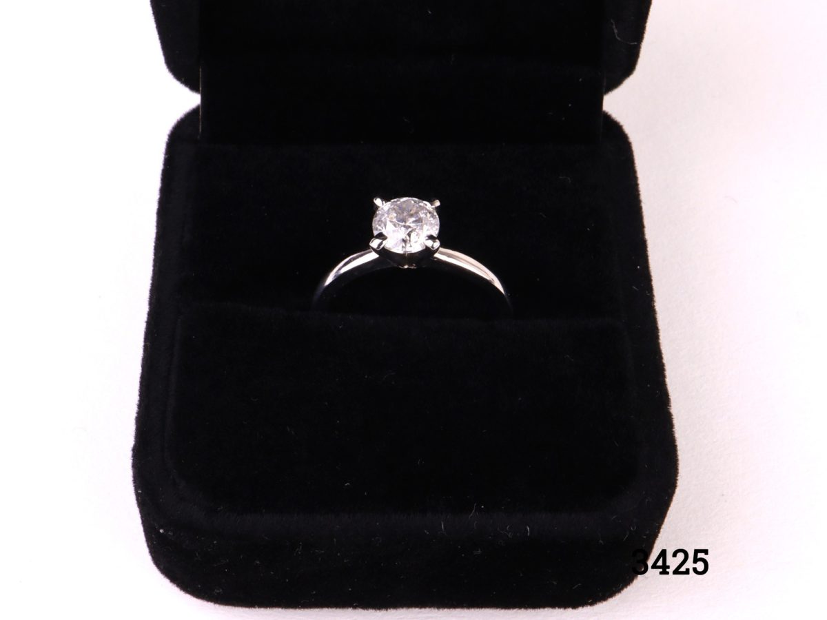 Vintage round brilliant cut 1.2 carat diamond solitaire reset onto modern 14kt white gold ring. SI1 clarity diamond with E colour. Box included. Size M.5 / 6.5. Weight 2.6g Close up of ring displayed in box