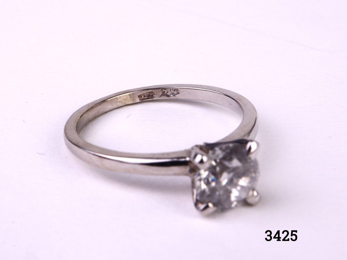 Vintage round brilliant cut 1.2 carat diamond solitaire reset onto modern 14kt white gold ring. SI1 clarity diamond with E colour. Box included. Size M.5 / 6.5. Weight 2.6g Photo of ring from a slight side angle showing hallmark